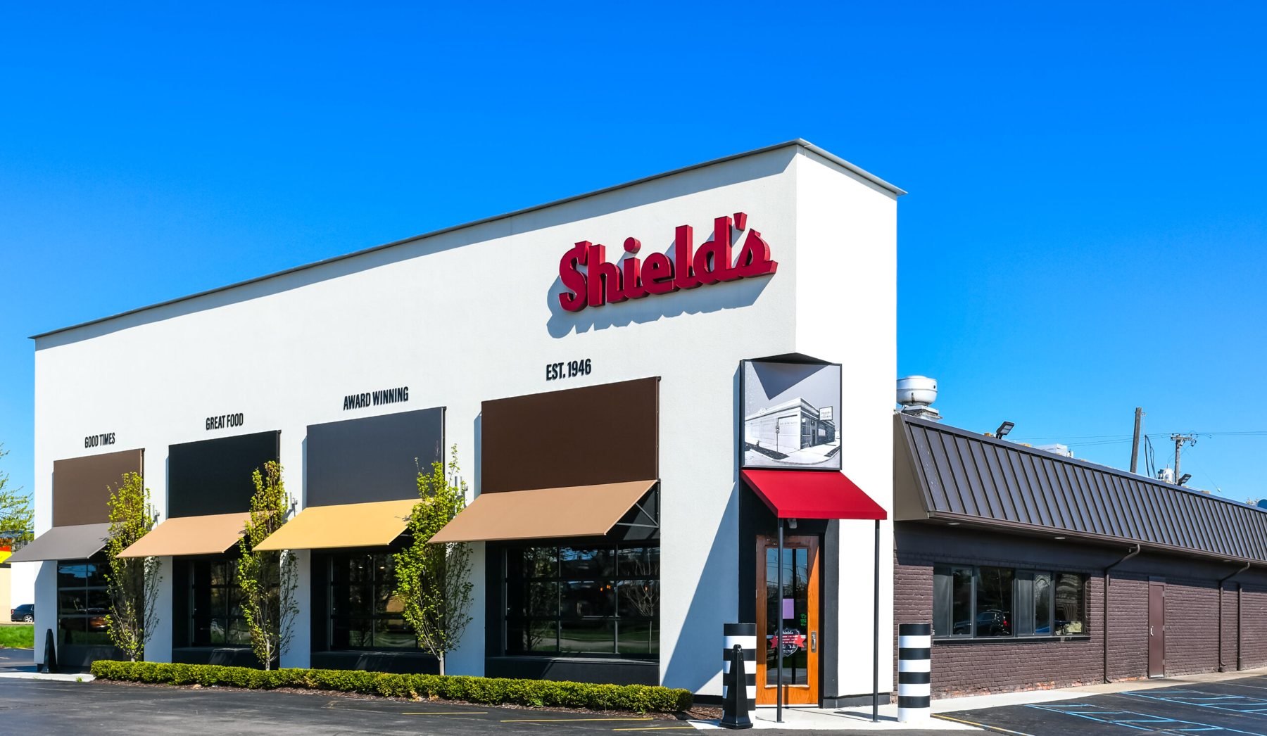 Exterior of Shield's Restaurant Bar Pizzeria with its red sign